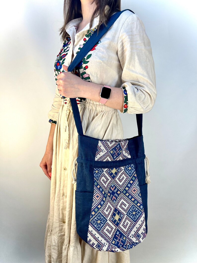 Handwoven blue drawstring bag with geometric embroidery, Boho crossbody bag, Ethnic-inspired backpack with adjustable straps