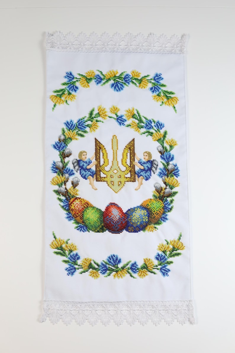 Ukrainian beaded Easter basket cover with trident & angels, Embroidered white cloth featuring floral motifs, Lace trim, and Easter eggs